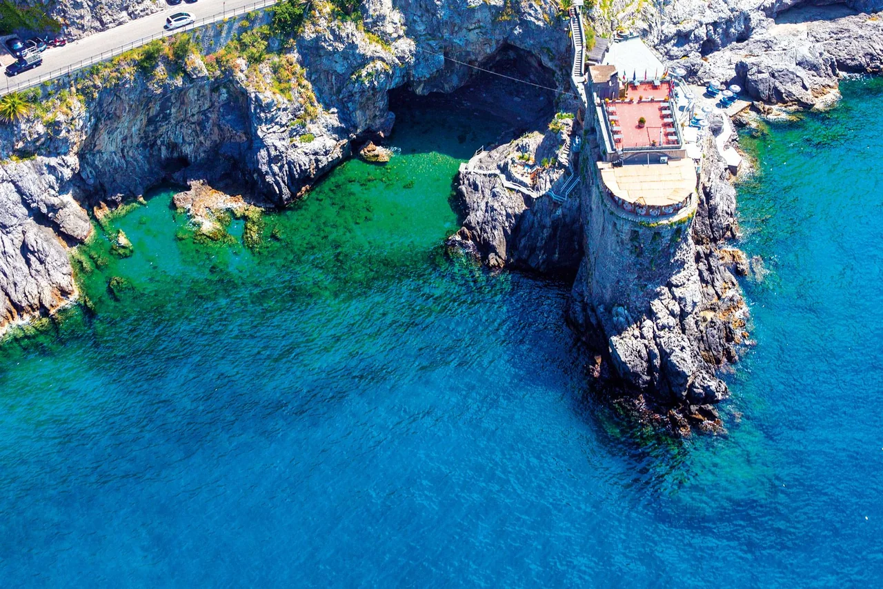Torre Normanna on Maiori’s rocky coast, with the restaurant terraces overlooking the sea